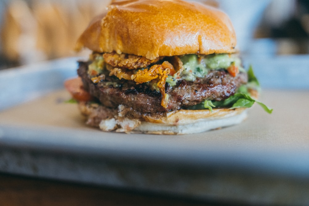 a close up of a hamburger on a tray