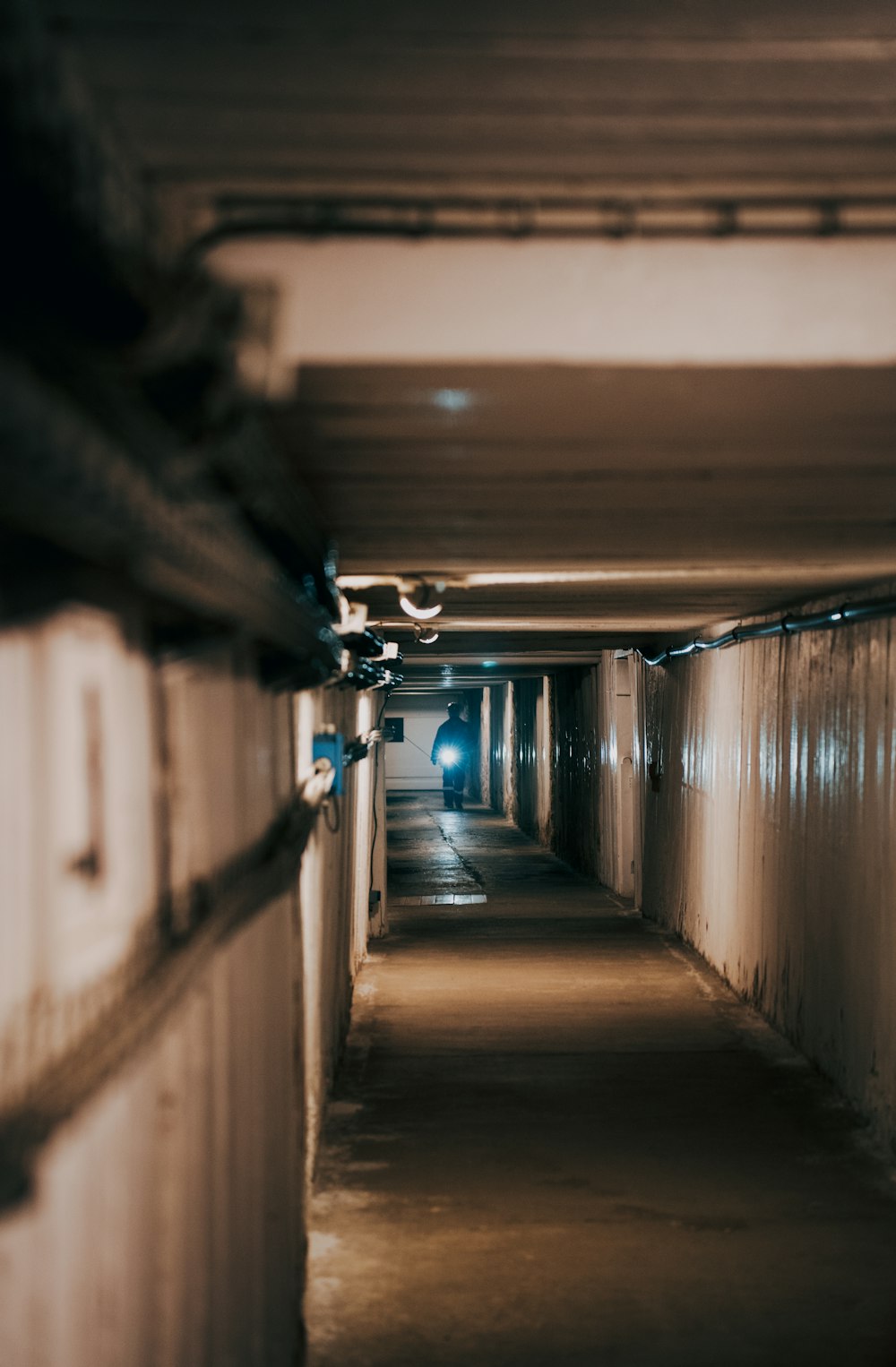 a long hallway with a light at the end of it