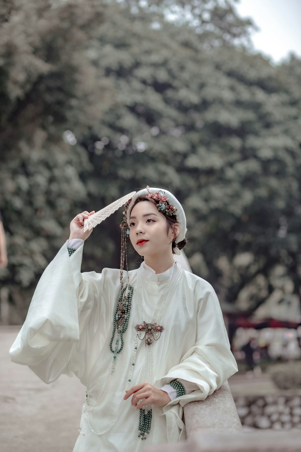 a woman wearing a white dress and a head scarf