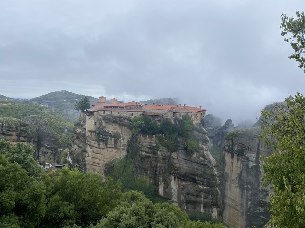 a village perched on a cliff surrounded by trees