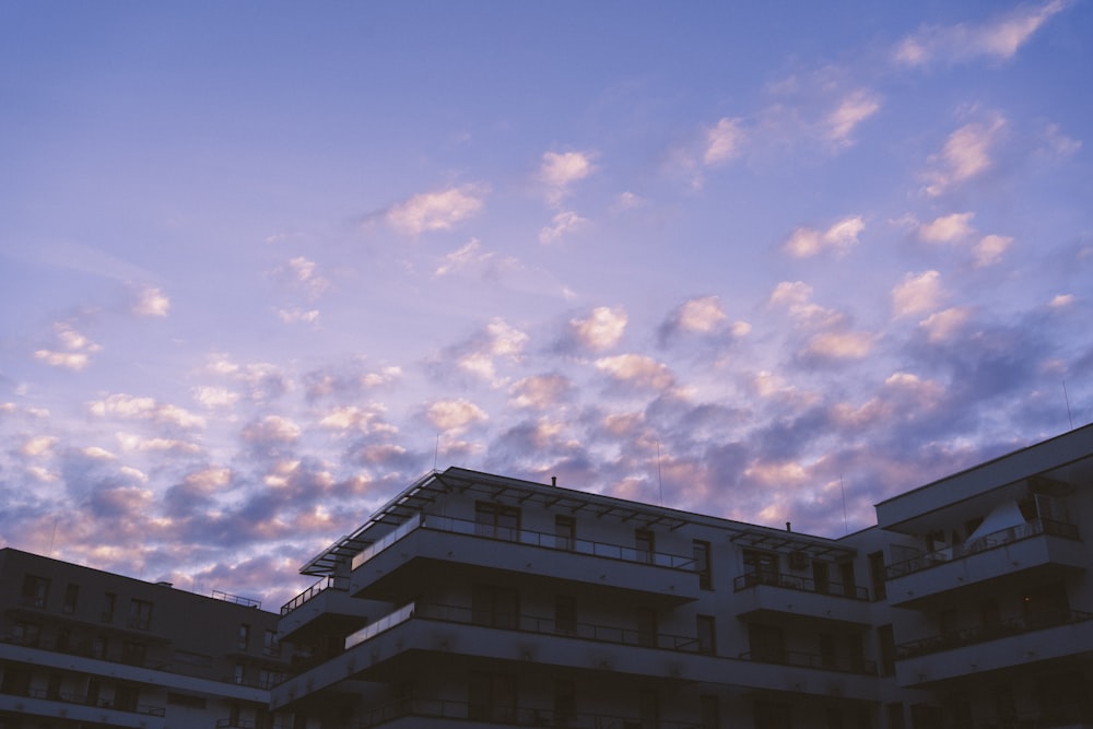 a building with balconies and balconies against a cloudy sky