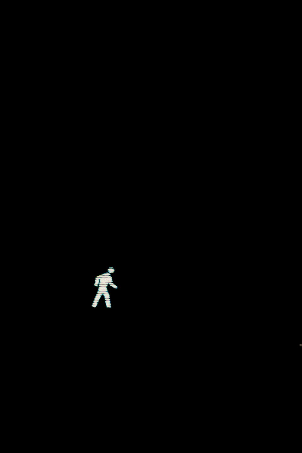 a person walking in the dark with a frisbee