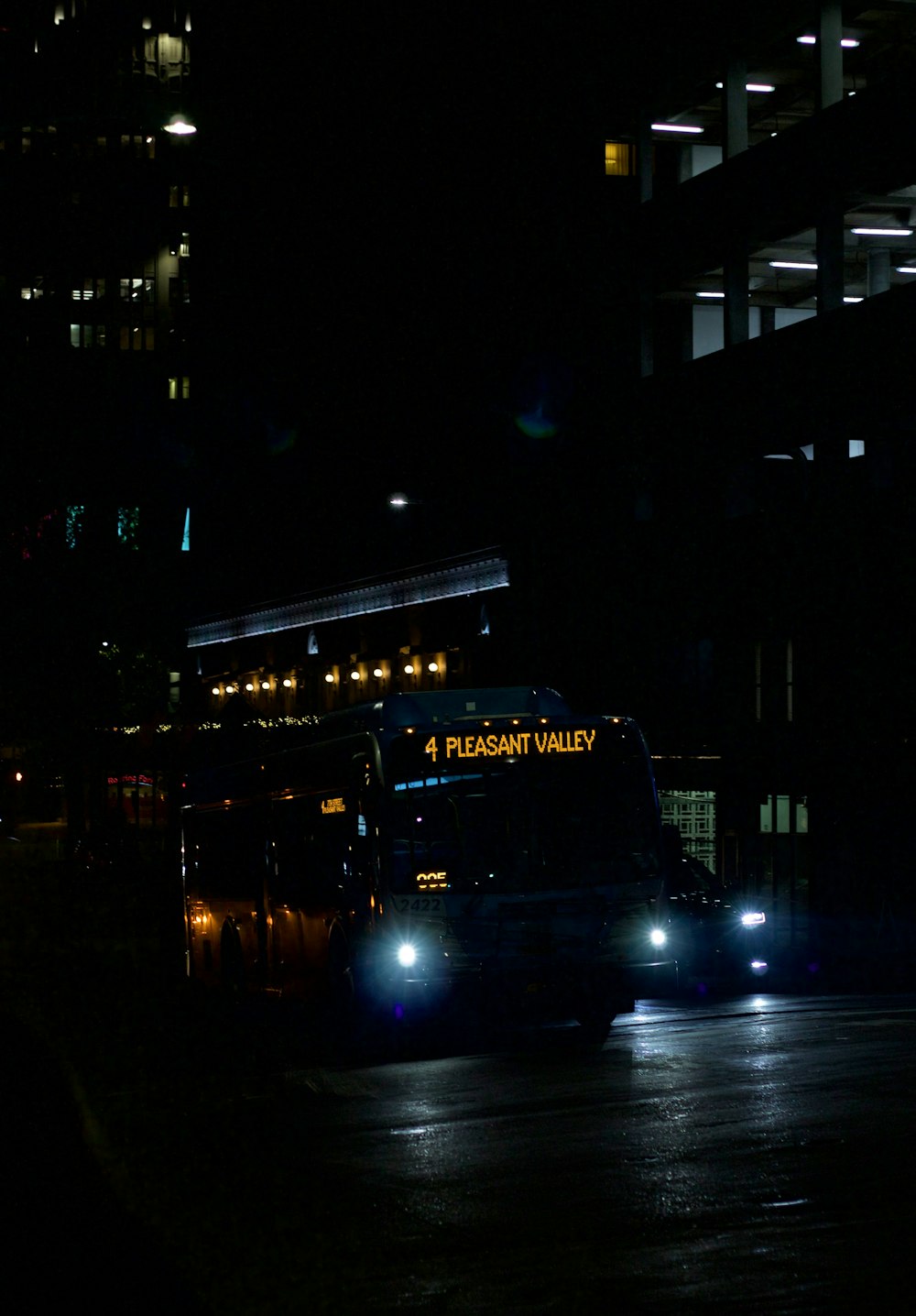 a bus driving down a street at night