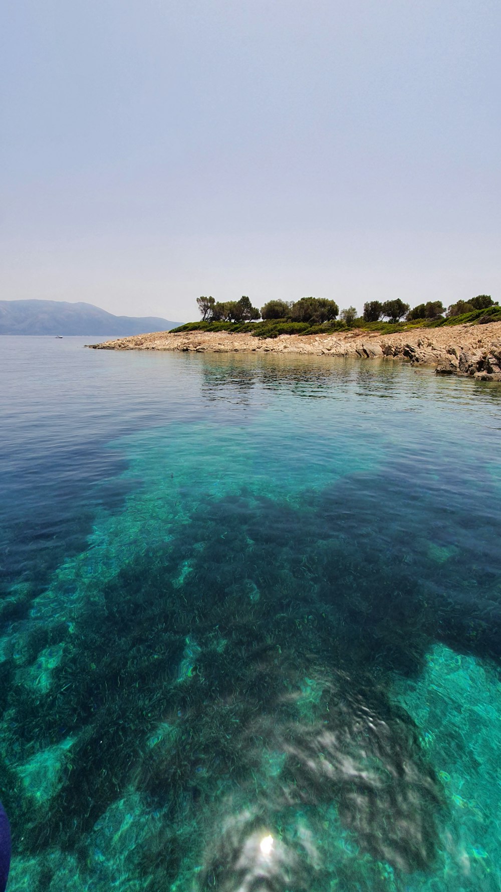 a body of water with a small island in the background