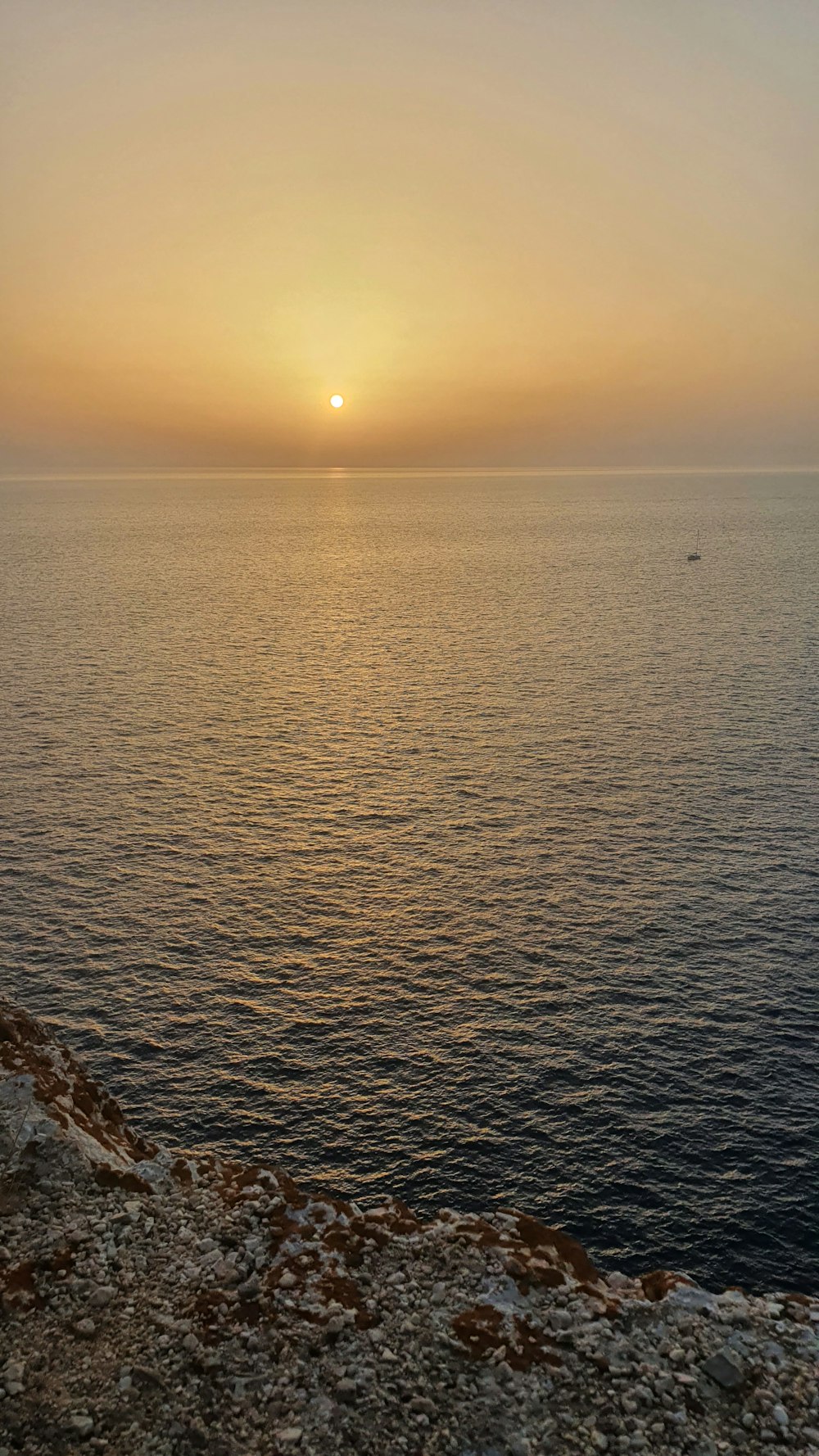 the sun is setting over the ocean on a clear day