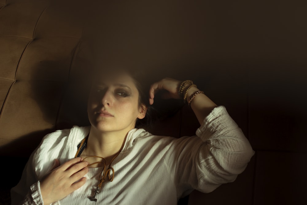 a woman in a white shirt and a necklace