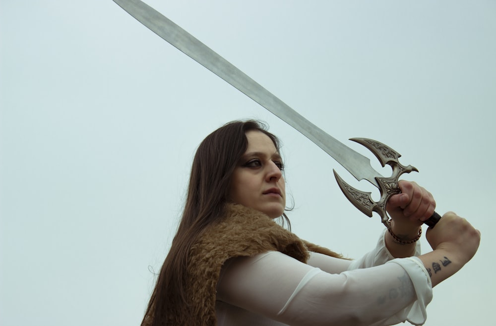 a woman with a sword and a scarf on