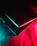 Close-up of a sleek, black 3D printed object with orange neon highlights on a dark background.