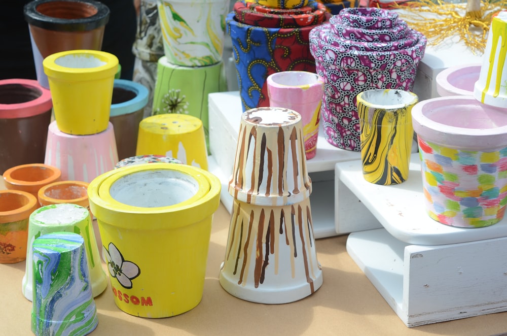 a table topped with lots of different colored vases