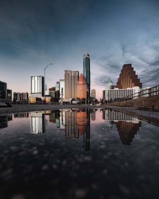 a bridge over a body of water with a city in the background