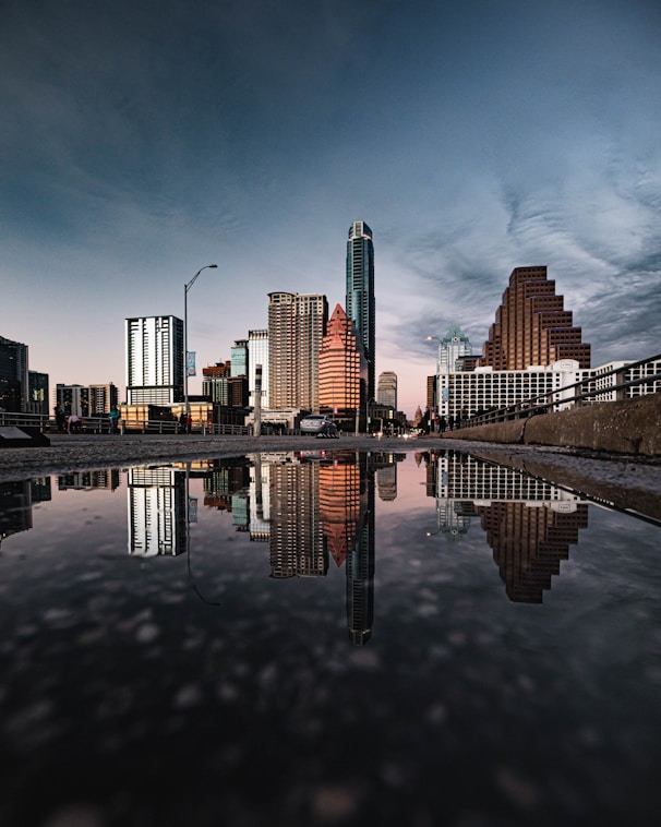 a bridge over a body of water with a city in the background