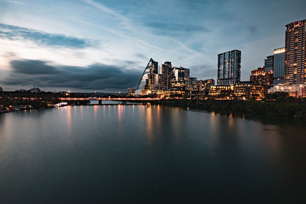 a bridge over a body of water with a city in the background