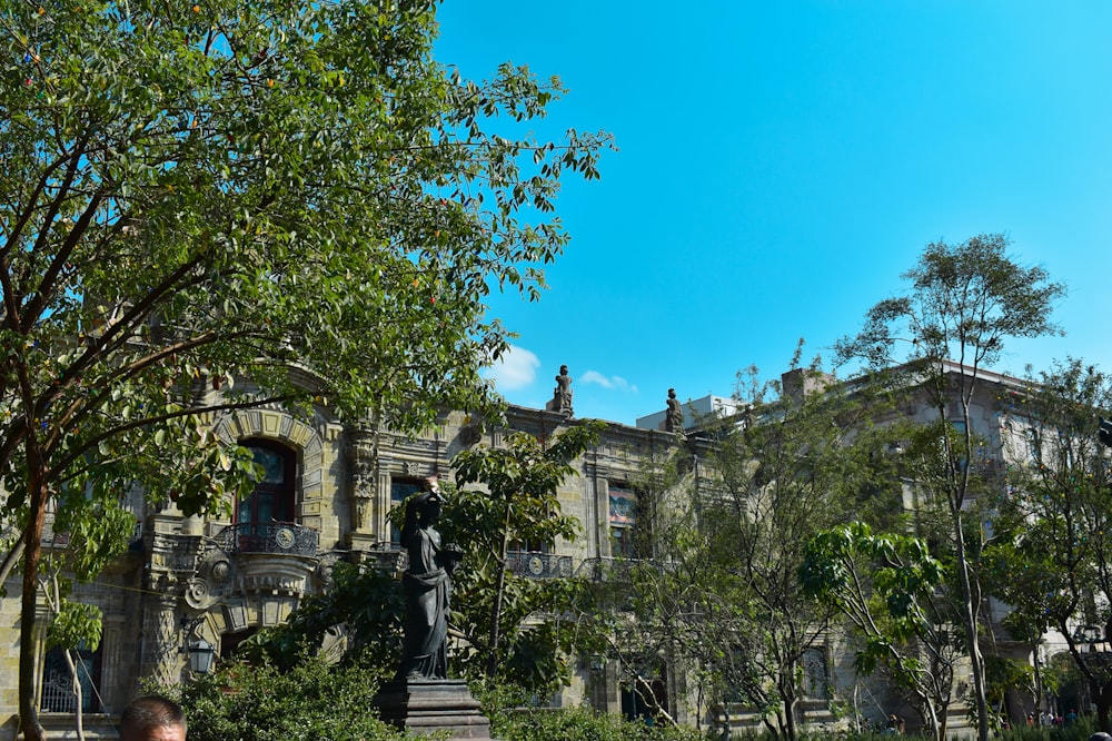 a statue in front of a large building