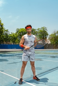 a man holding a tennis racquet on a tennis court