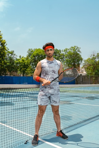 a man holding a tennis racquet on a tennis court