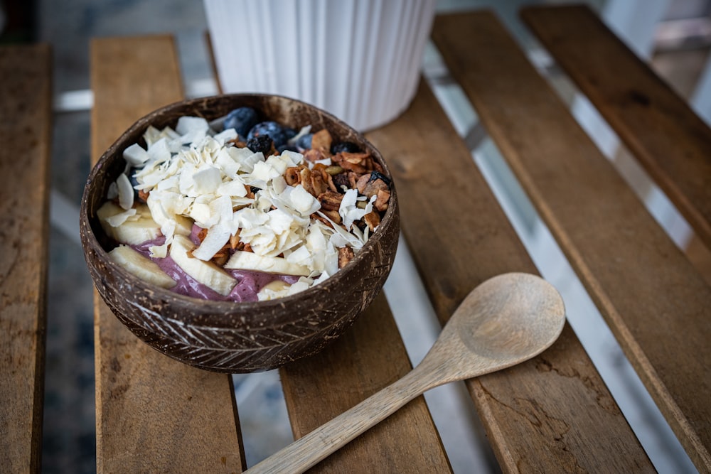 a bowl of food sitting on top of a wooden table