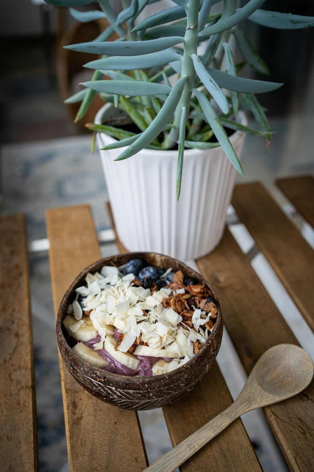 a bowl of food sitting on top of a wooden table