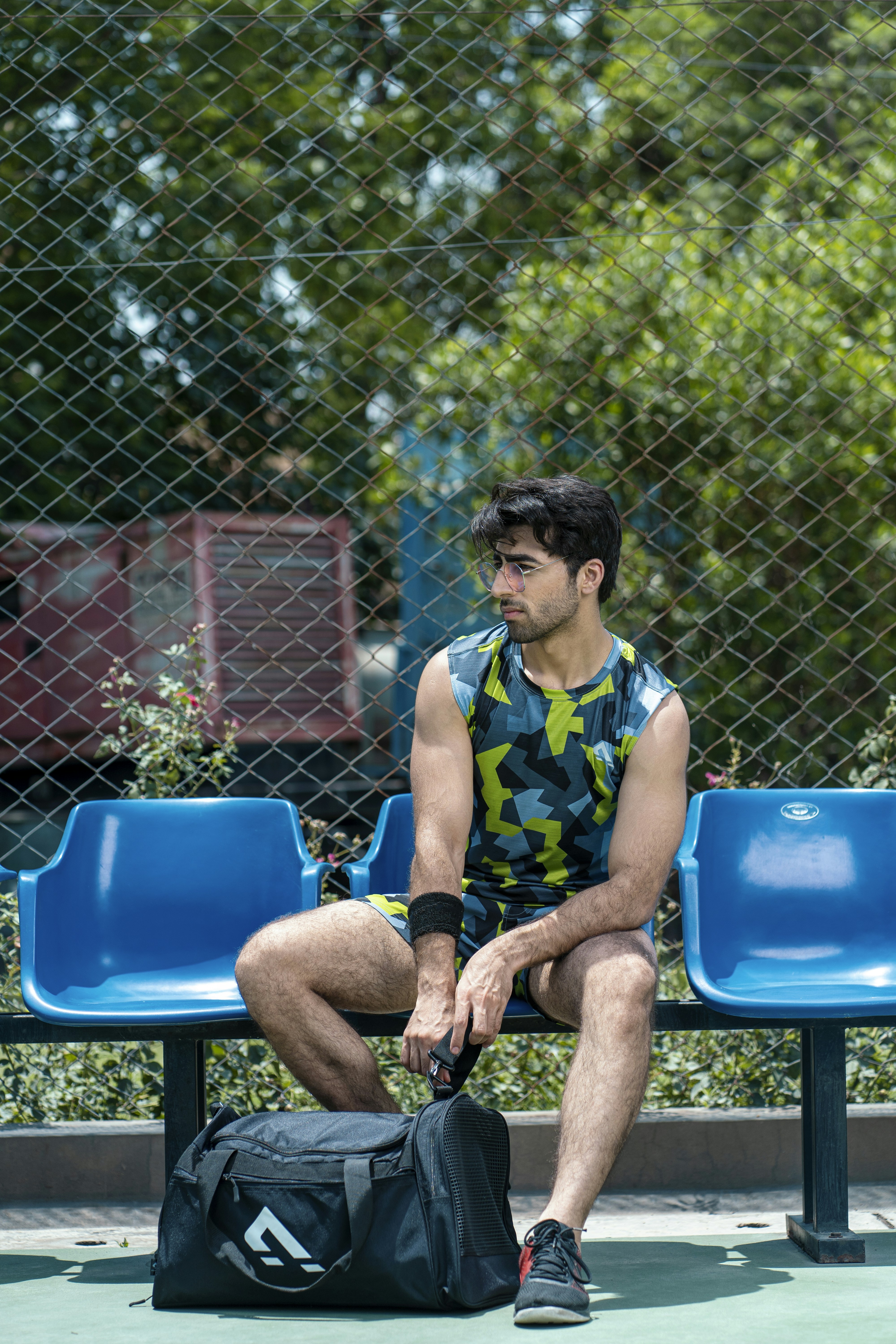 a man sitting on a bench with a bag