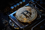 a bitcoin on top of a computer motherboard