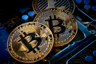 three bitcoins sitting on top of a computer motherboard