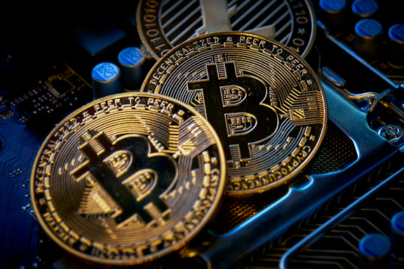 three bitcoins sitting on top of a computer motherboard