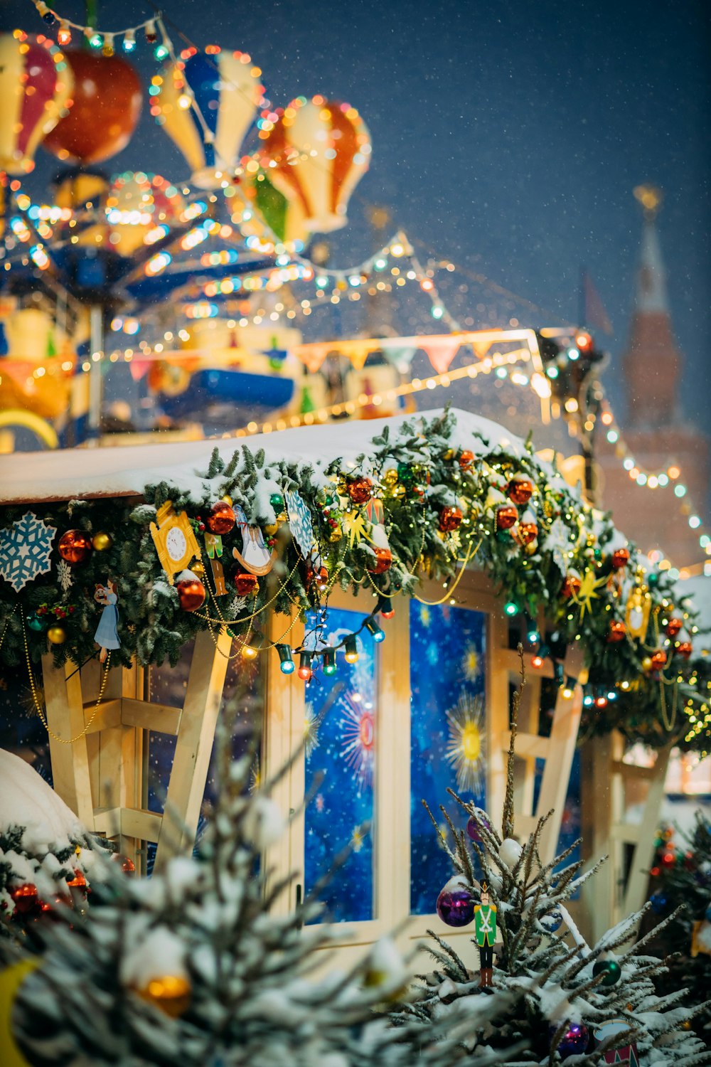 a merry christmas scene with a carousel in the background