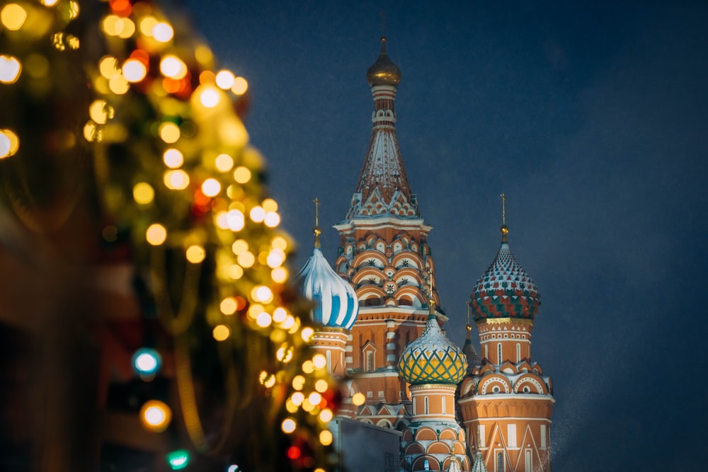 a very tall building with a christmas tree in front of it