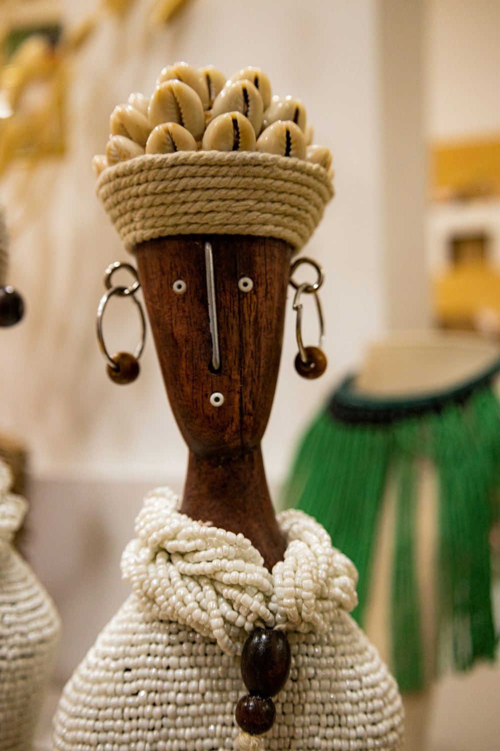 a wooden mannequin with a basket of bananas on it's head