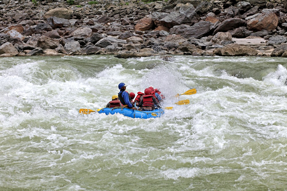 a group of people riding on top of a raft down a river