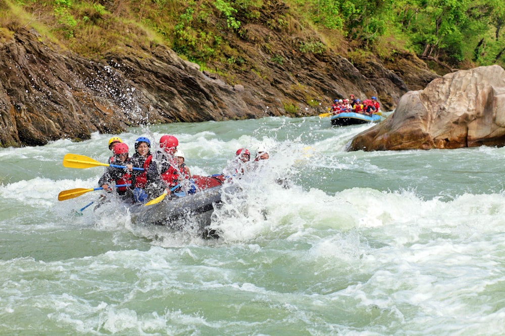 a group of people are rafting down a river