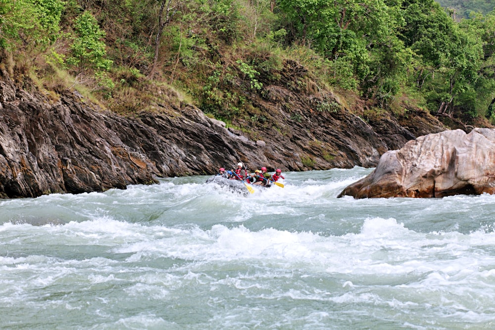 a group of people in a raft on a river