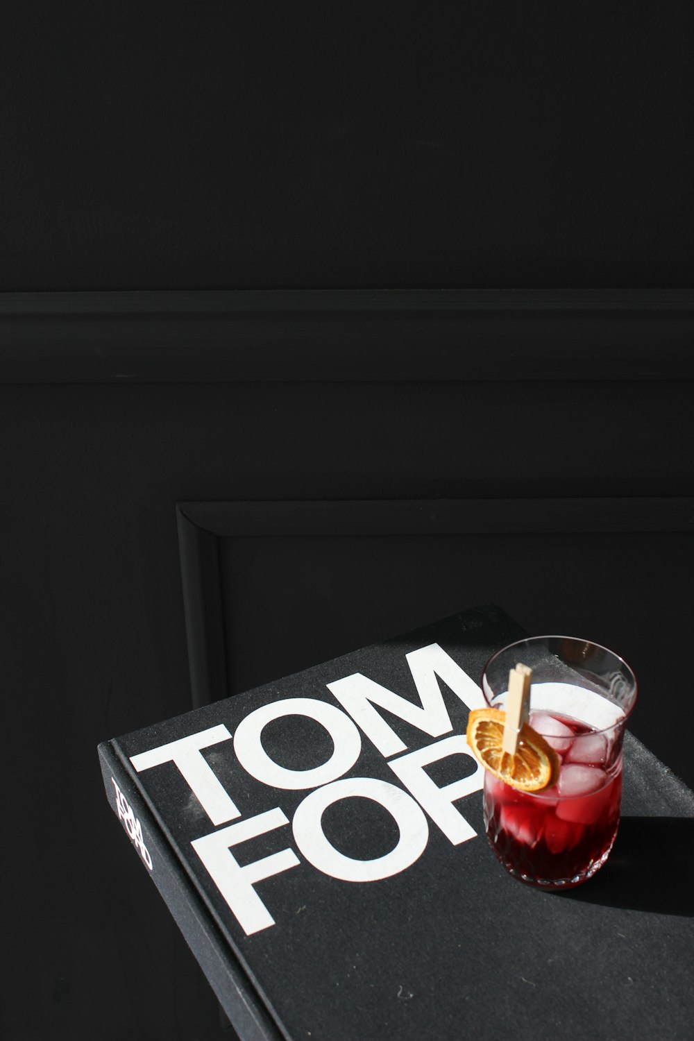 a cocktail sitting on top of a book on a table