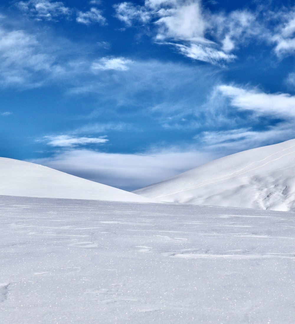 a man riding skis down a snow covered slope