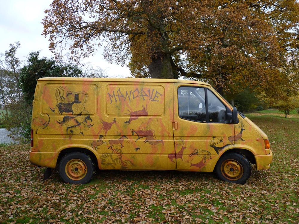 A yellow van with graffiti on the side of it photo – Free Vehicle Image on  Unsplash