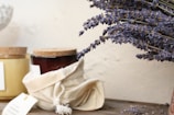 a jar of honey and some lavender flowers on a table