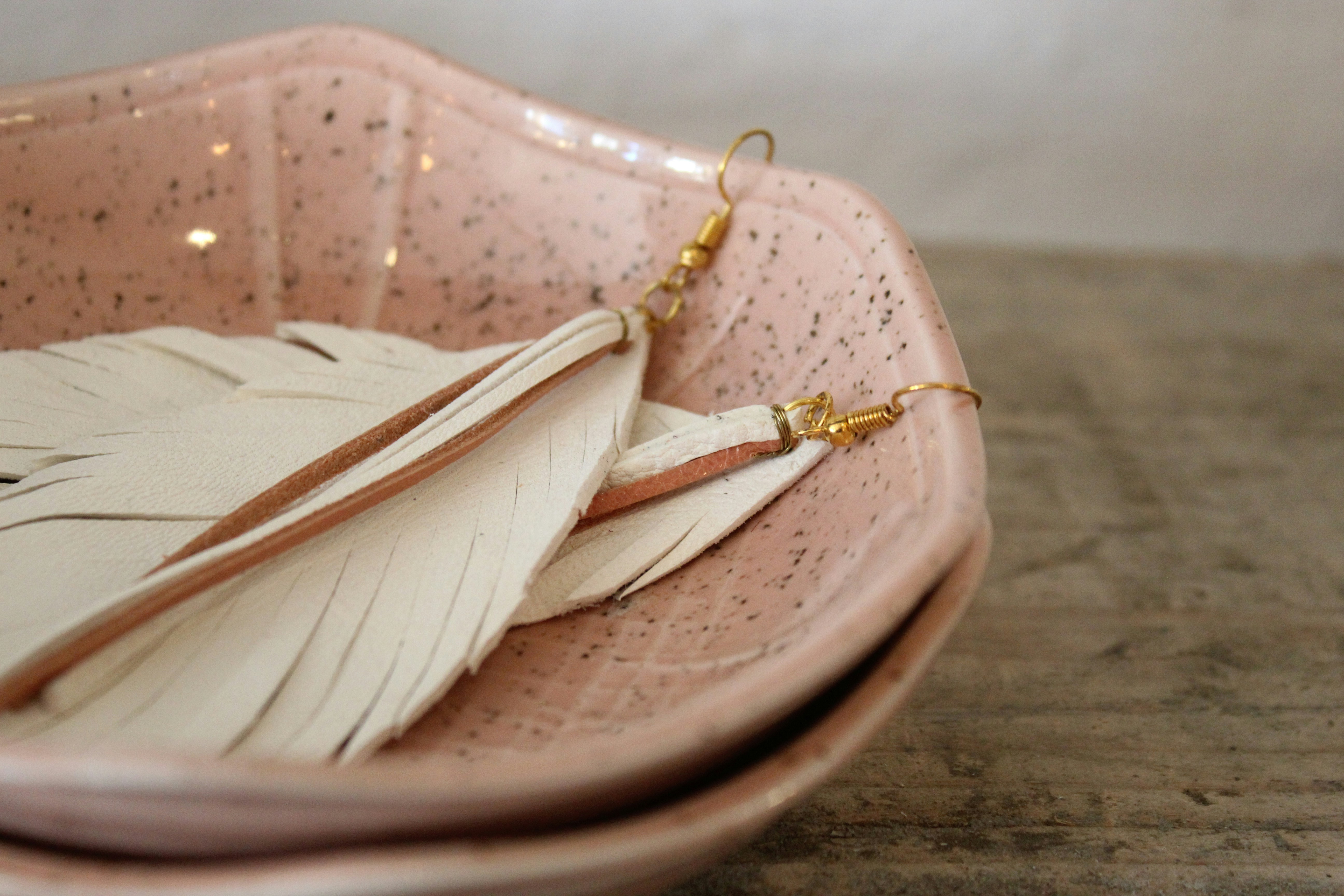 a close up of a plate with a pair of earrings