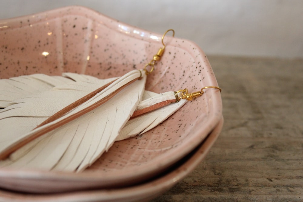 a close up of a plate with a pair of earrings