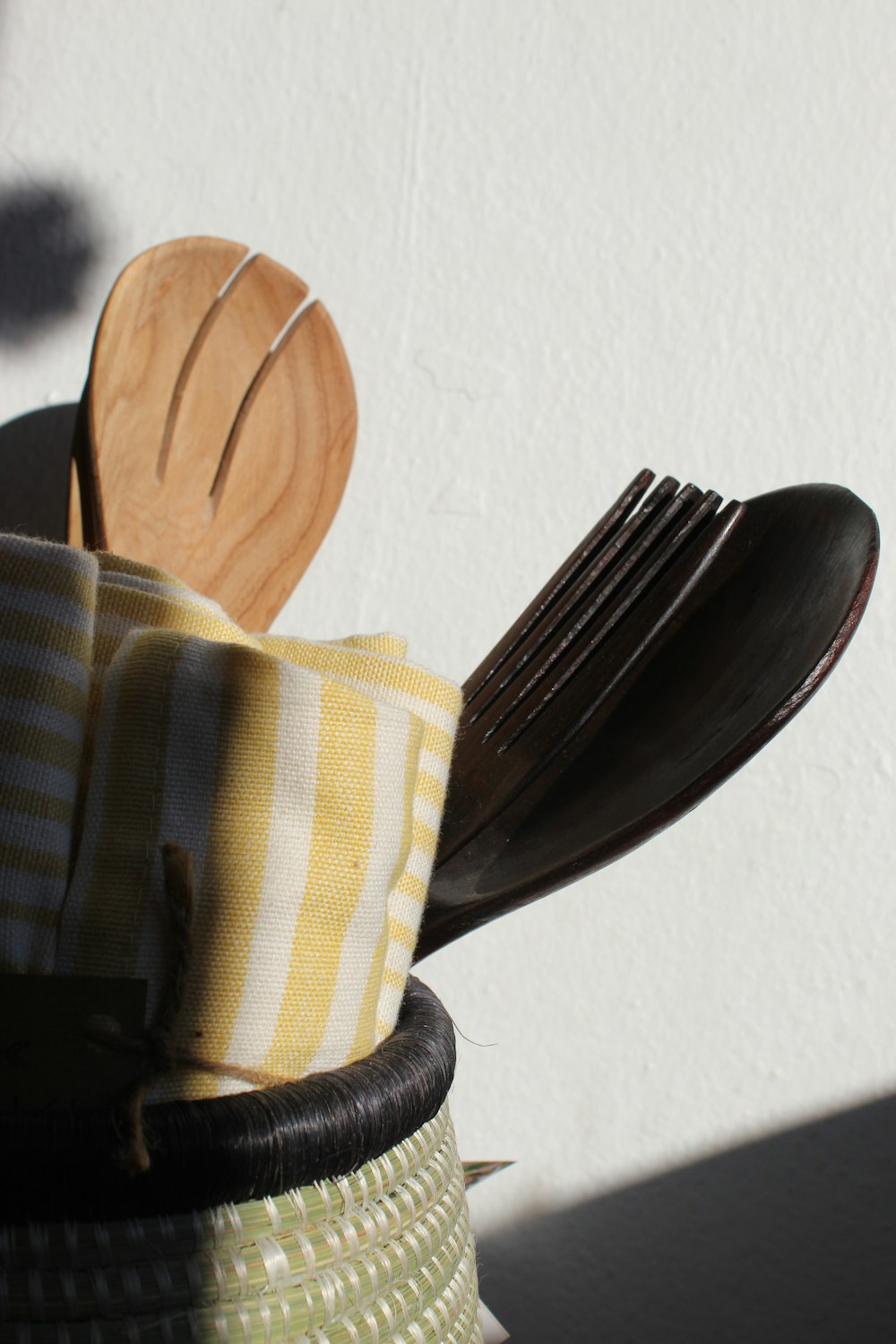 a close up of a basket with utensils in it