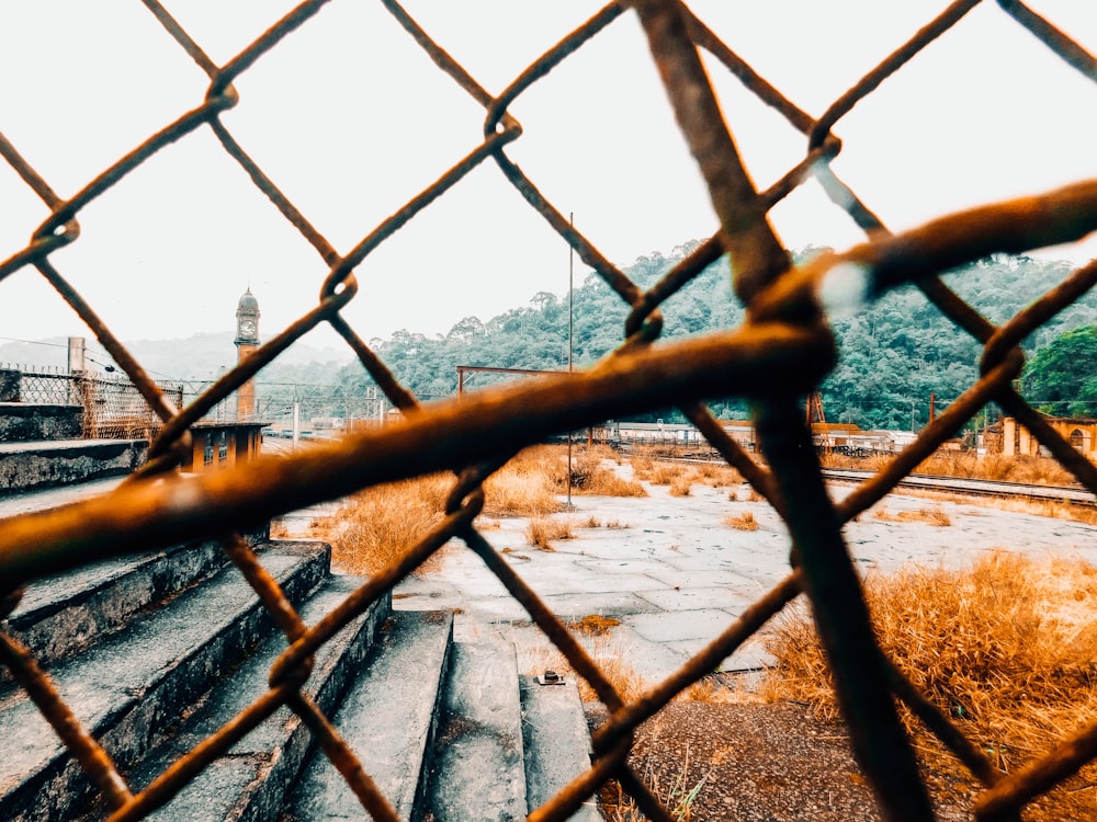 a view through a chain link fence of a building