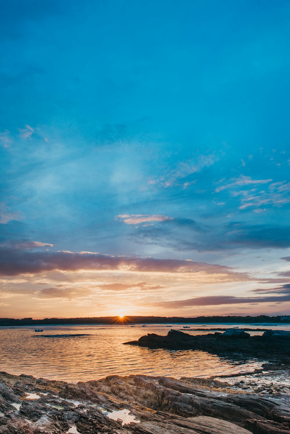 the sun is setting over a body of water