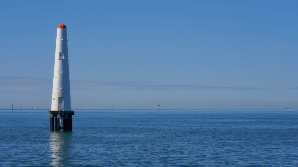 a light house in the middle of a body of water