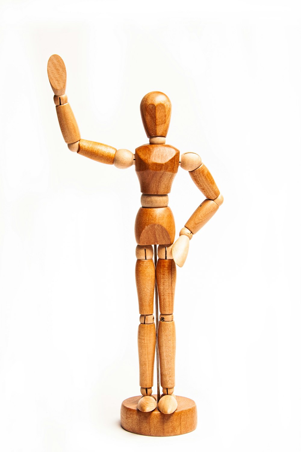 a wooden toy figure holding a piece of wood