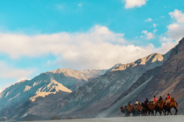 Riders crossing a Himalayan valley