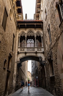 a couple of people that are walking under a bridge