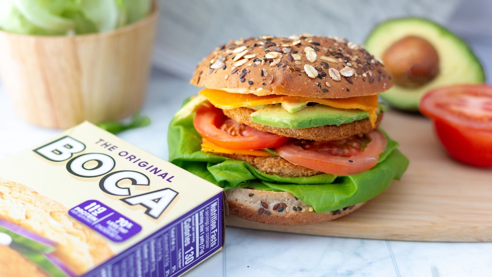 a hamburger sitting on top of a wooden cutting board