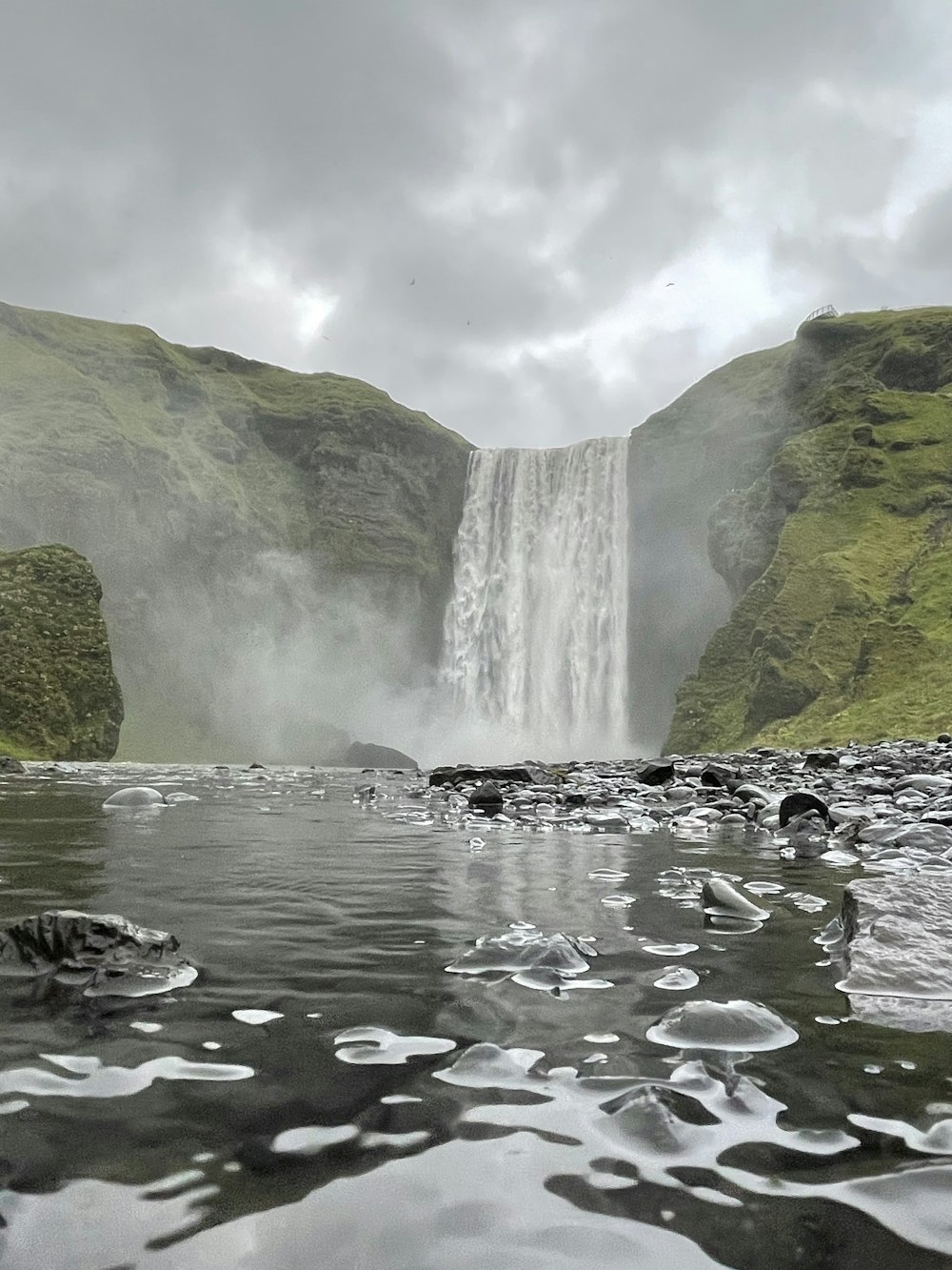 a waterfall with a waterfall in the background