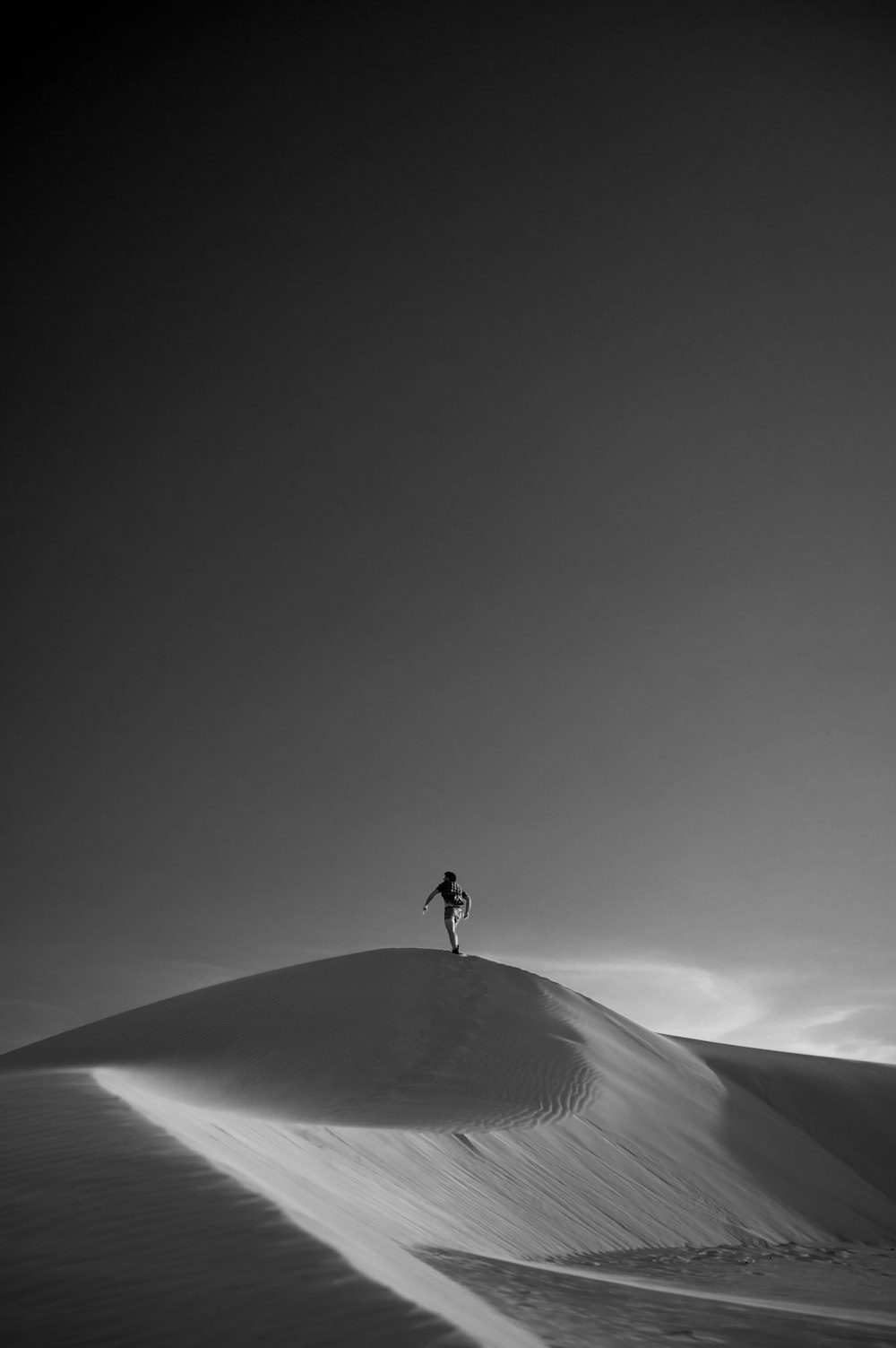 a person standing on top of a snow covered hill