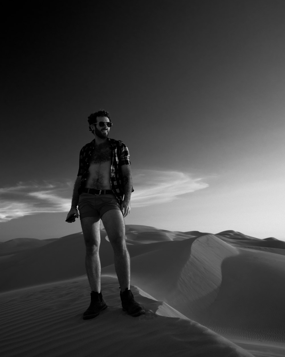 a man standing in the middle of a desert