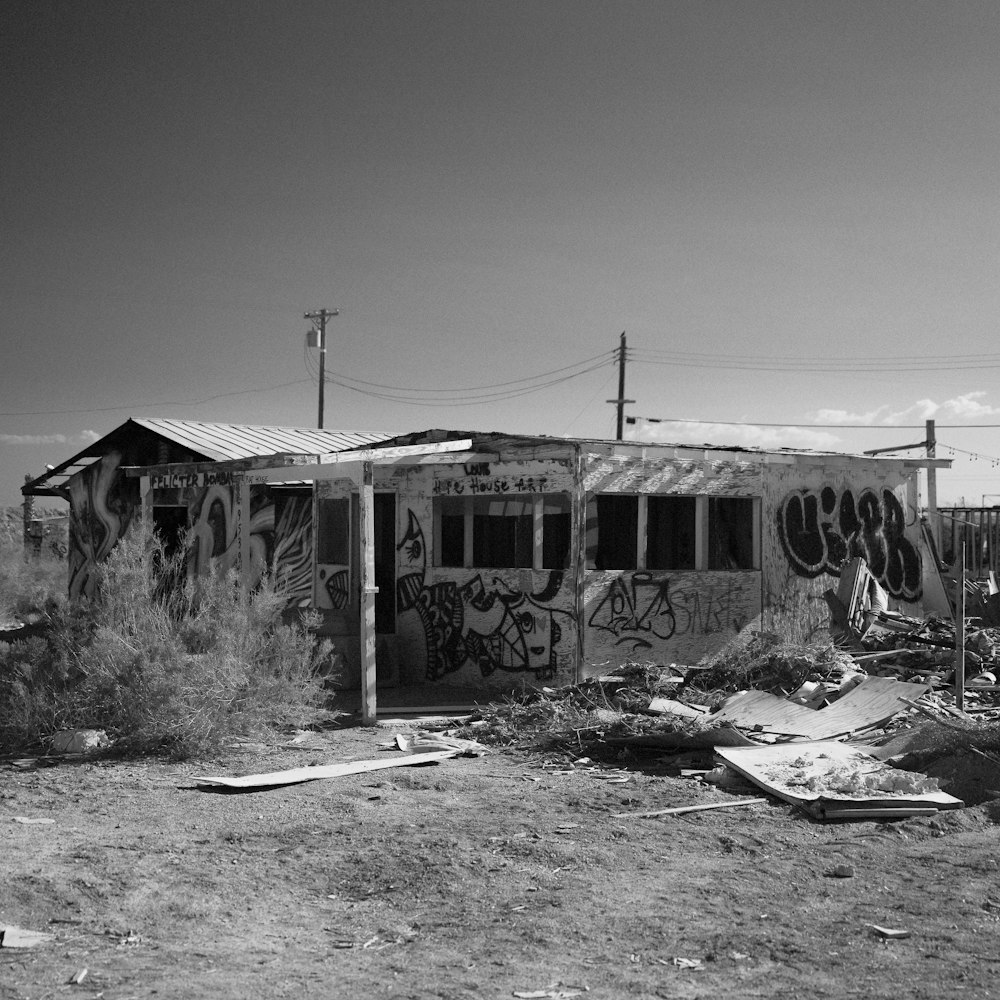 a black and white photo of a building with graffiti on it