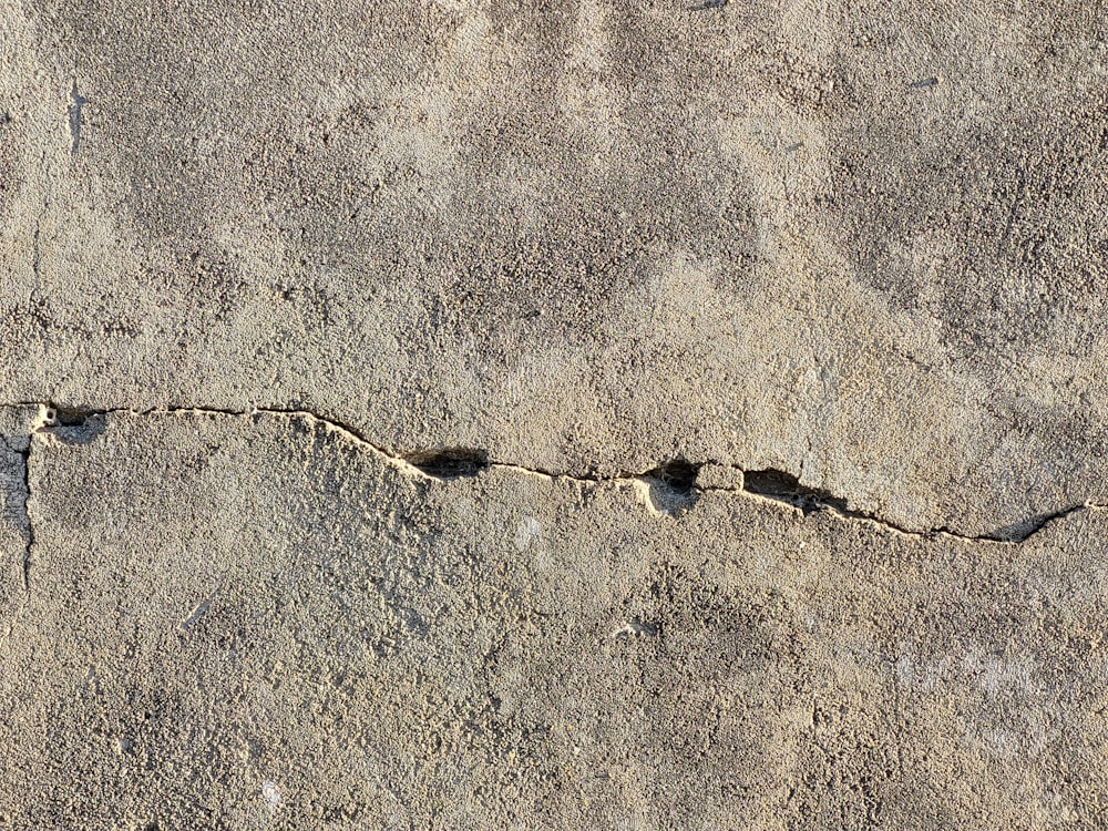 a close up of a crack in a concrete wall
